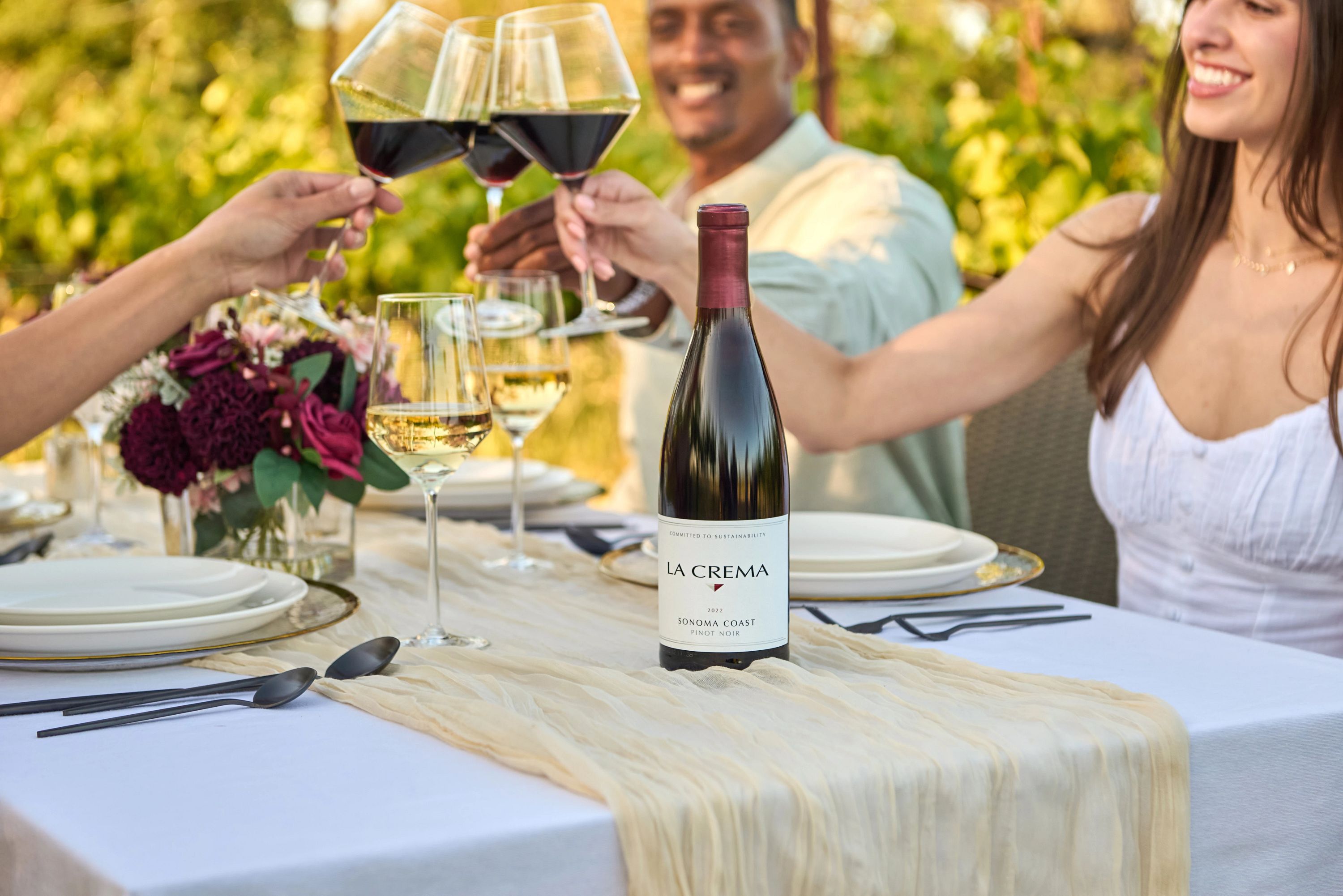 Friends enjoying La Crema Pinot Noir outside