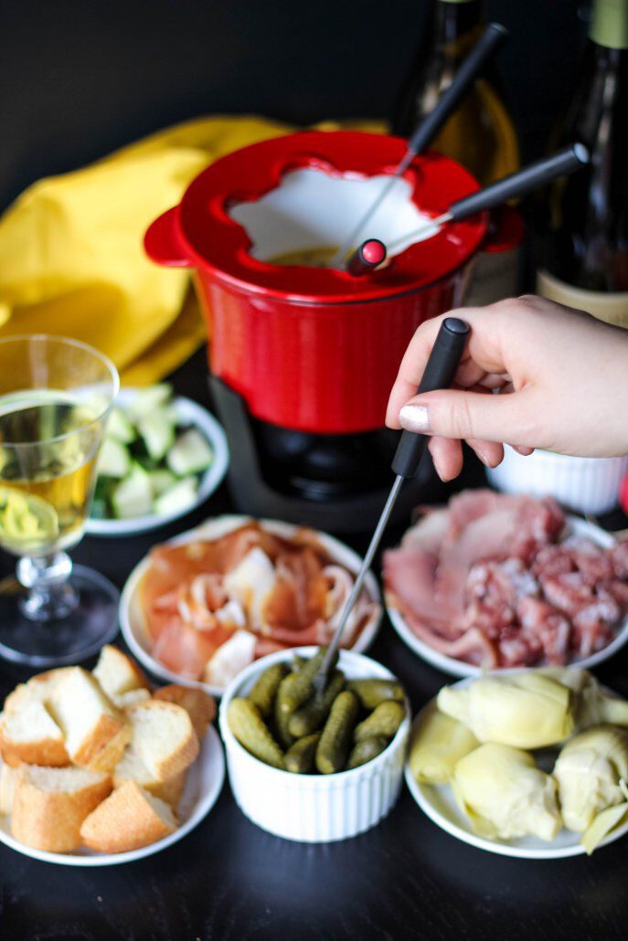 Fondue with snacks and sliced meats