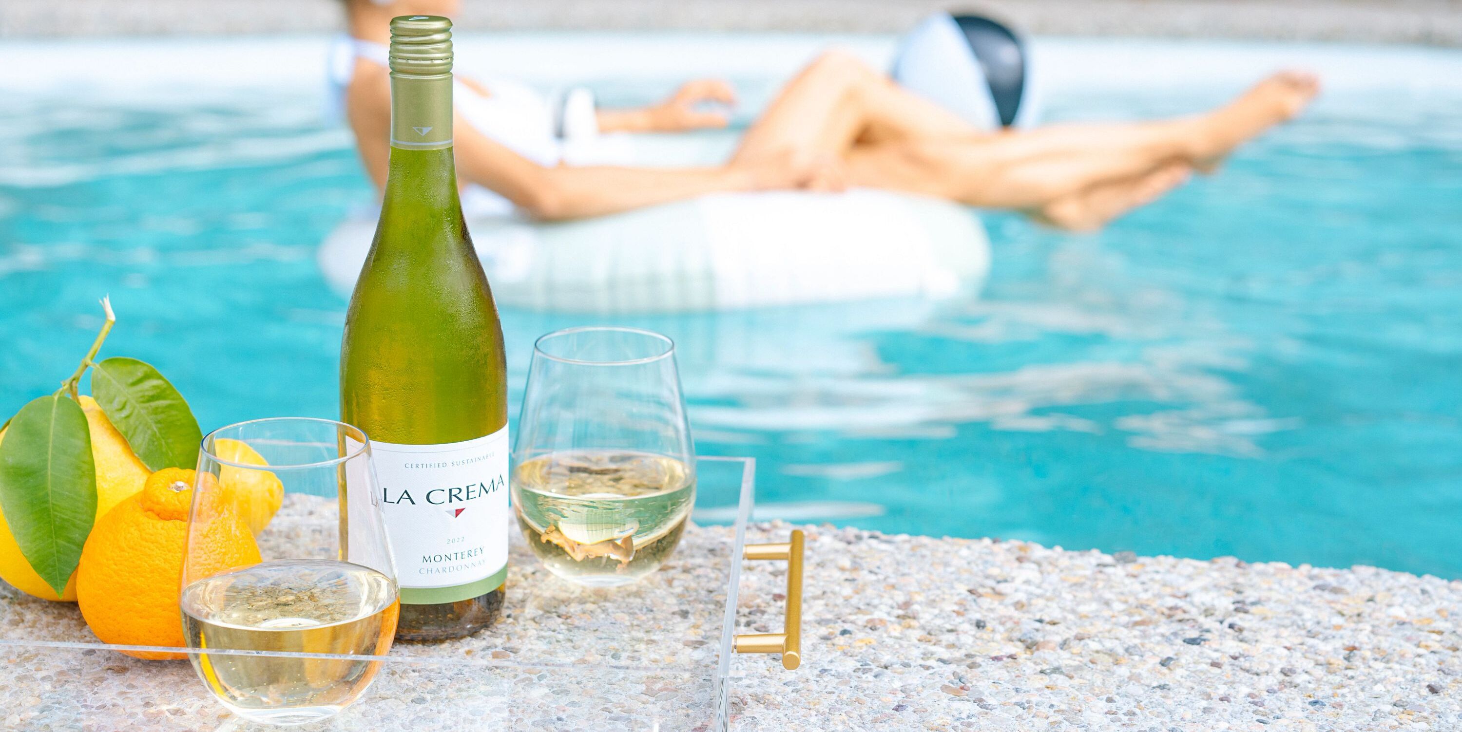 Drinking La Crema wine by the pool