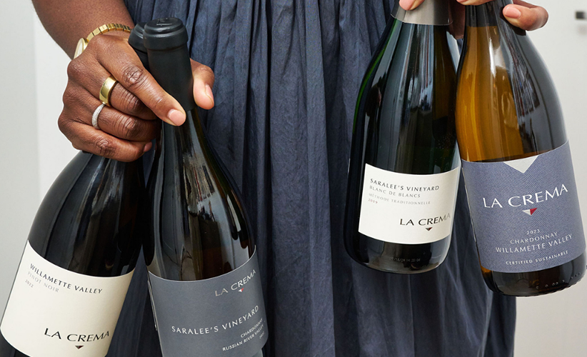 Amber holding four bottles of la crema wine