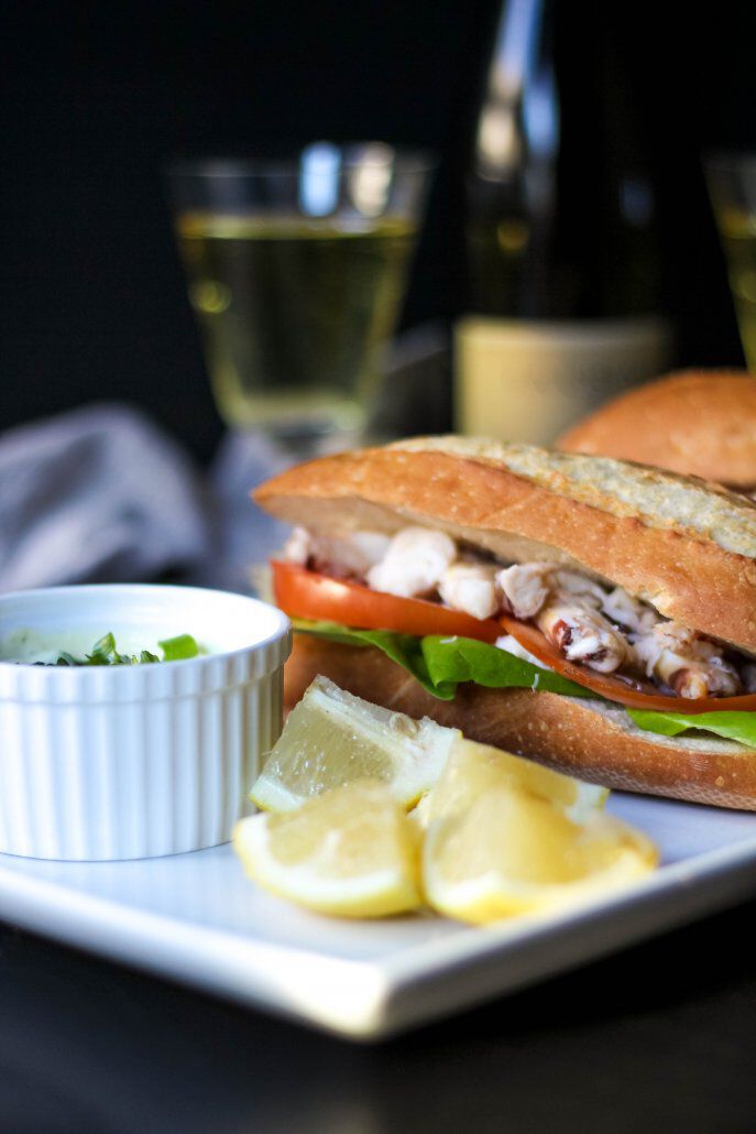 Dungeness Crab Sandwich with lemon wedges