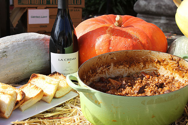Beef stew with wine, bread and a pumpkin