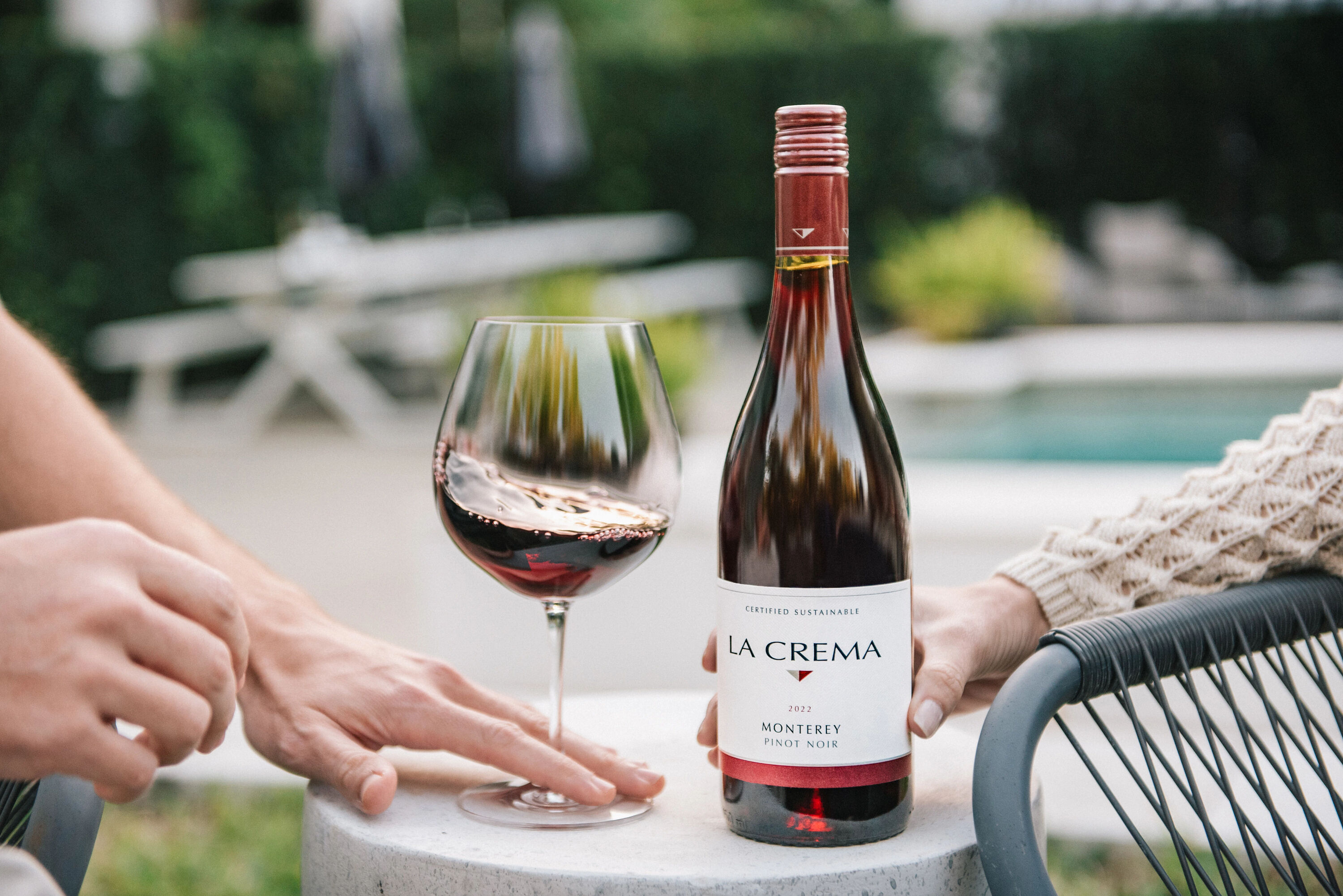 La Crema Pinot Noir wine bottle with a glass