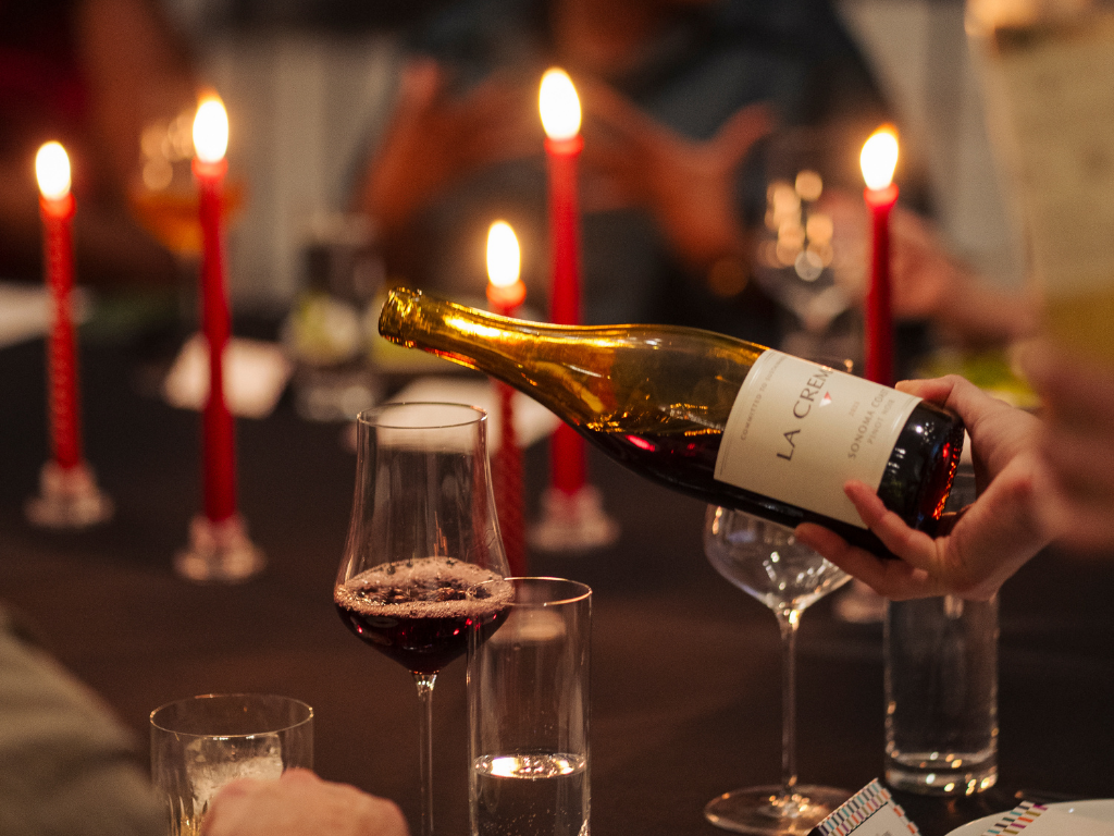 Pouring a bottle of La Crema Pinot Noir at the holidays