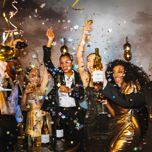 A group celebrating with bottles of La Crema wine