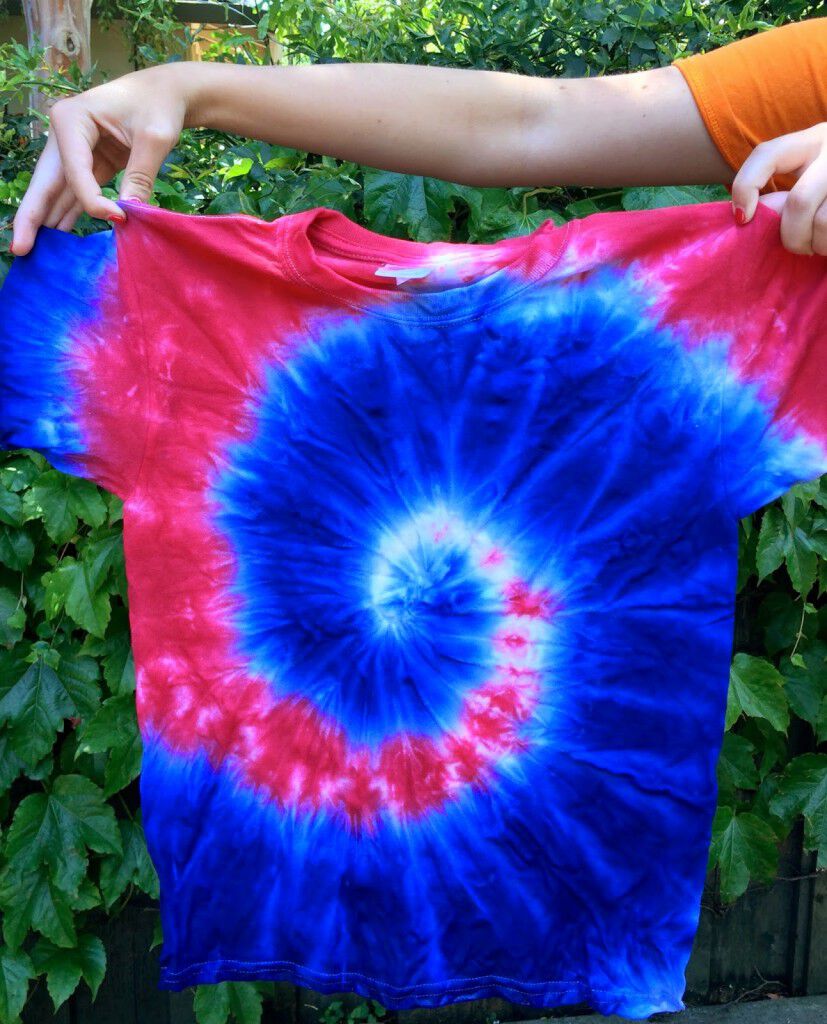 Holding a tie dye shirt