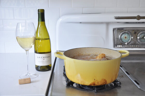 Cooking fried chicken with a glass of La Crema Chardonnay