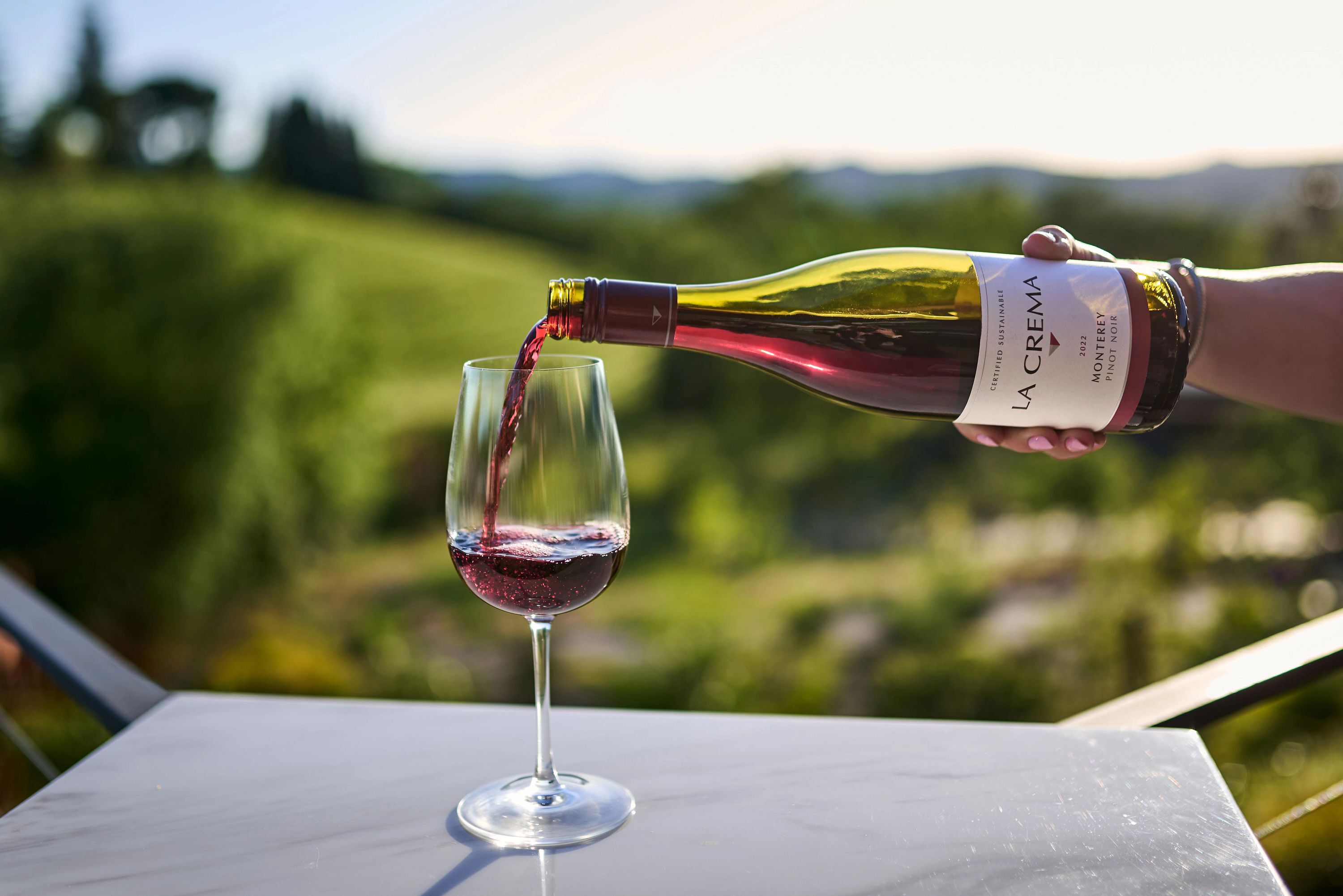 La Crema Pinot Noir wine being poured outside