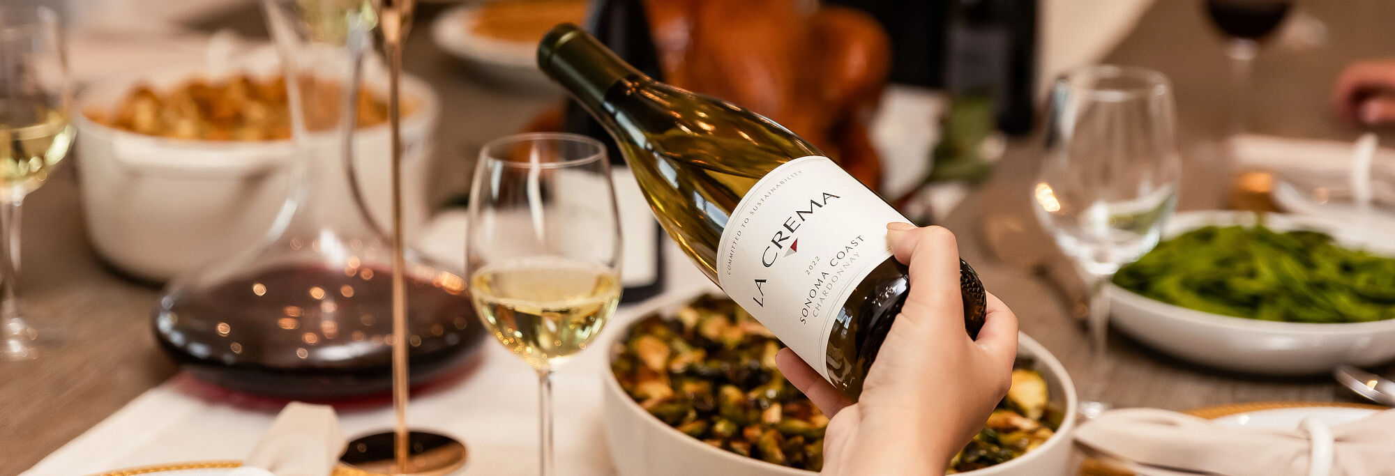 Pouring a glass of La Crema Chardonnay at the Thanksgiving table