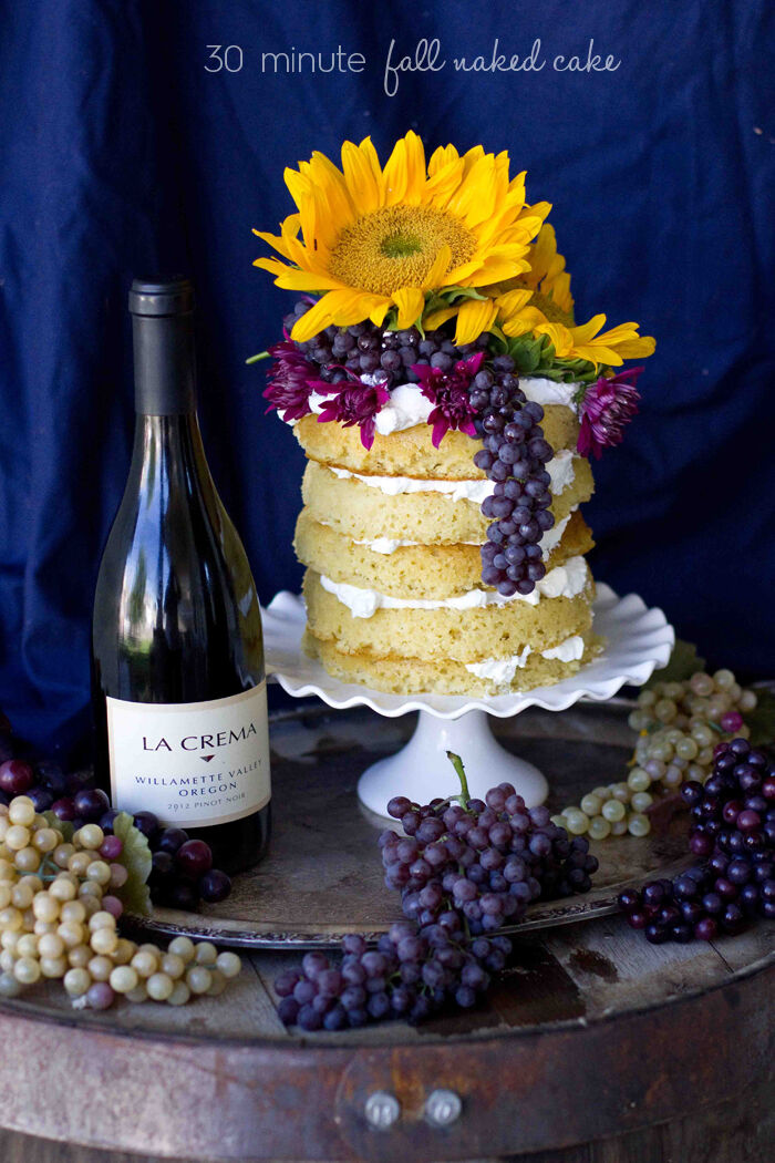 Naked cake with flowers, grapes and a bottle of La Crema wine