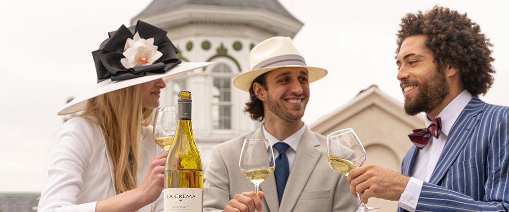 3 friends at the Kentucky derby enjoying wine