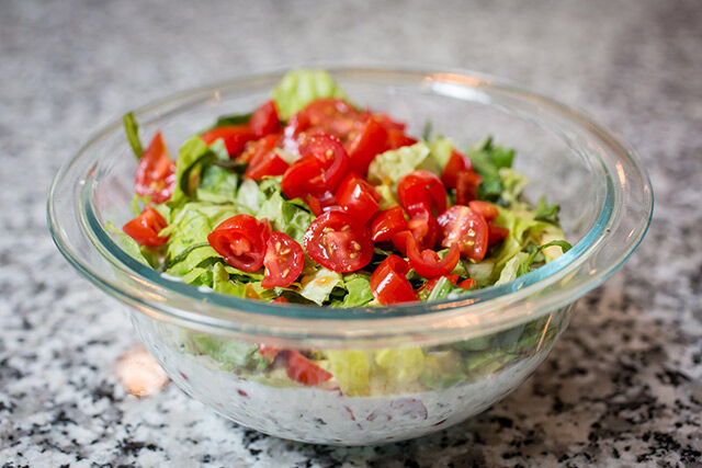 Blt dip in a transparent bowl on a marble countertop