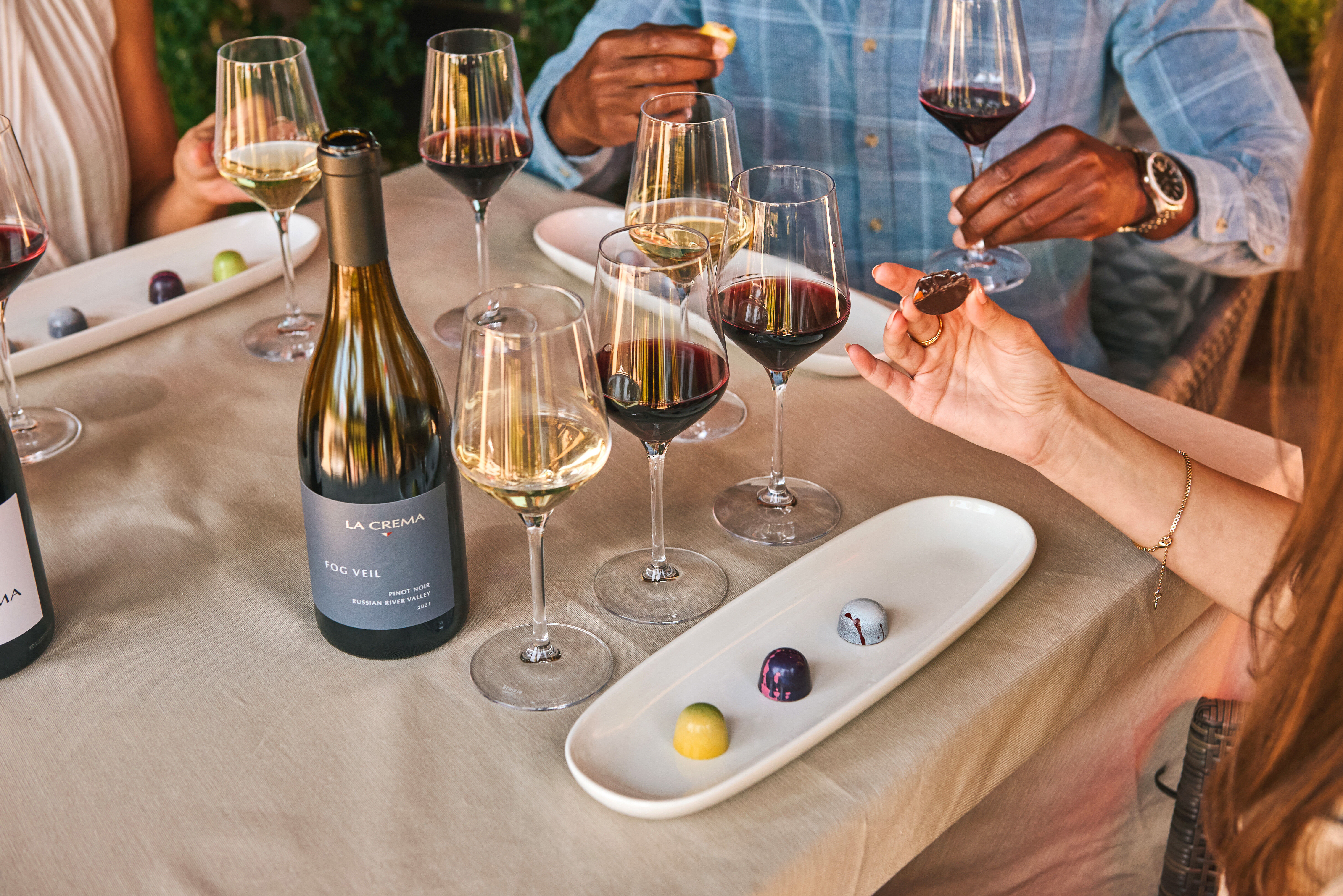 Three women walking through the La Crema vineyard