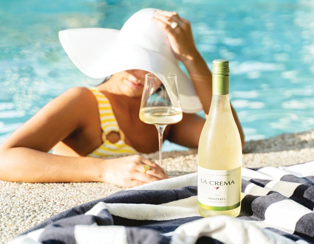 A women drinking La Crema Pinot Gris by the pool