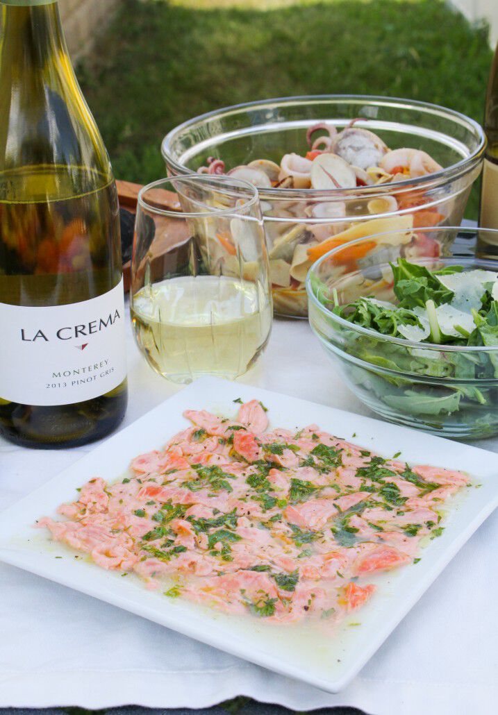 Salmon carpaccio with salad and wine