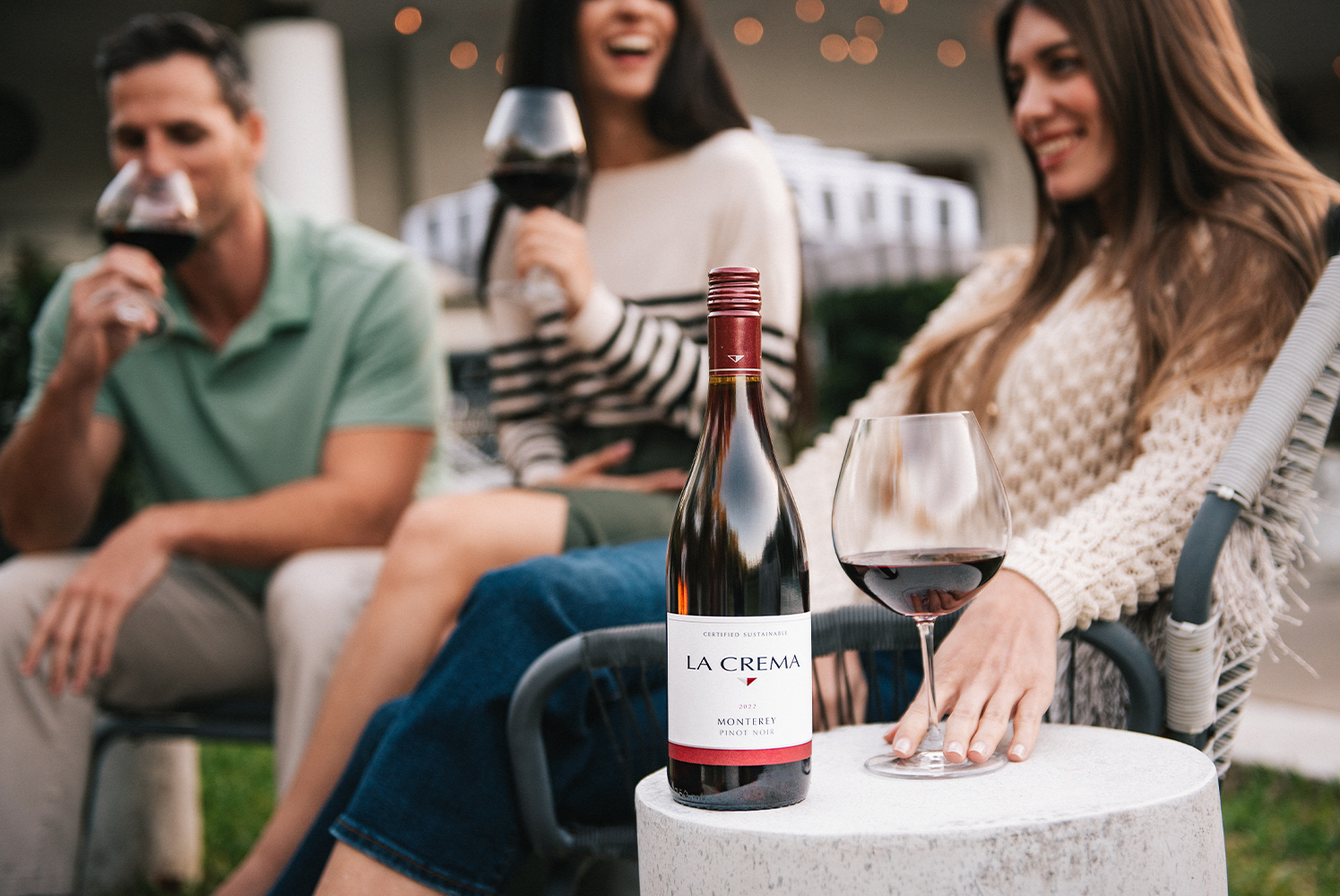 Three friend enjoying a glass of Monterey Pinot Noir