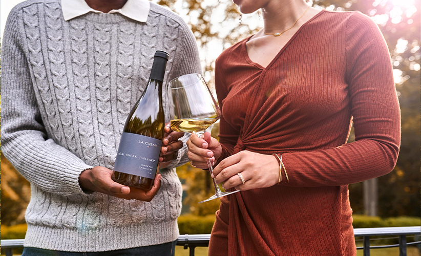 Man and woman enjoying a glass of chardonnay at La Crema's vineyard