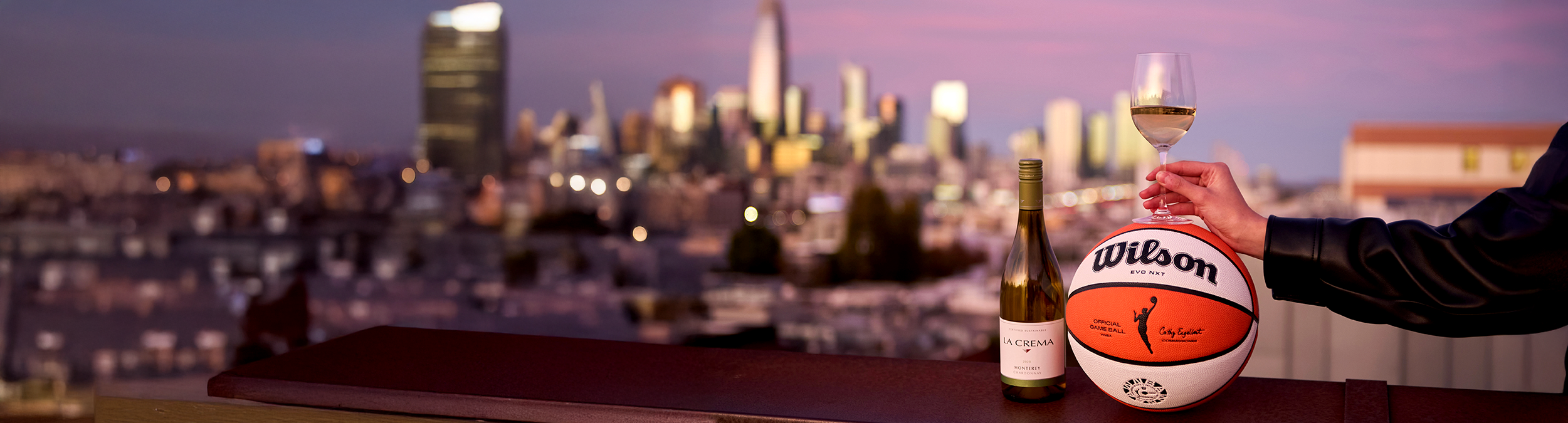 WNBA partnership La Crema glass of chardonnay with basketball