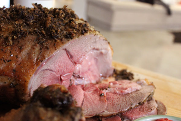 A sliced roasted leg of lamb