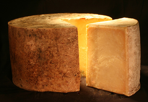 A cut wheel of Fiscalini Cheddar