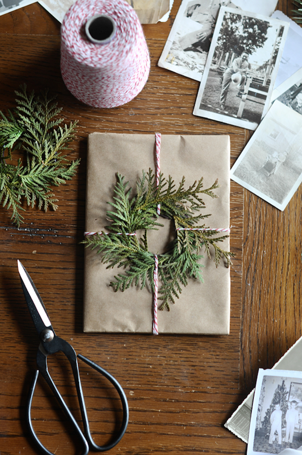 Wrapped present with evergreen wreath.