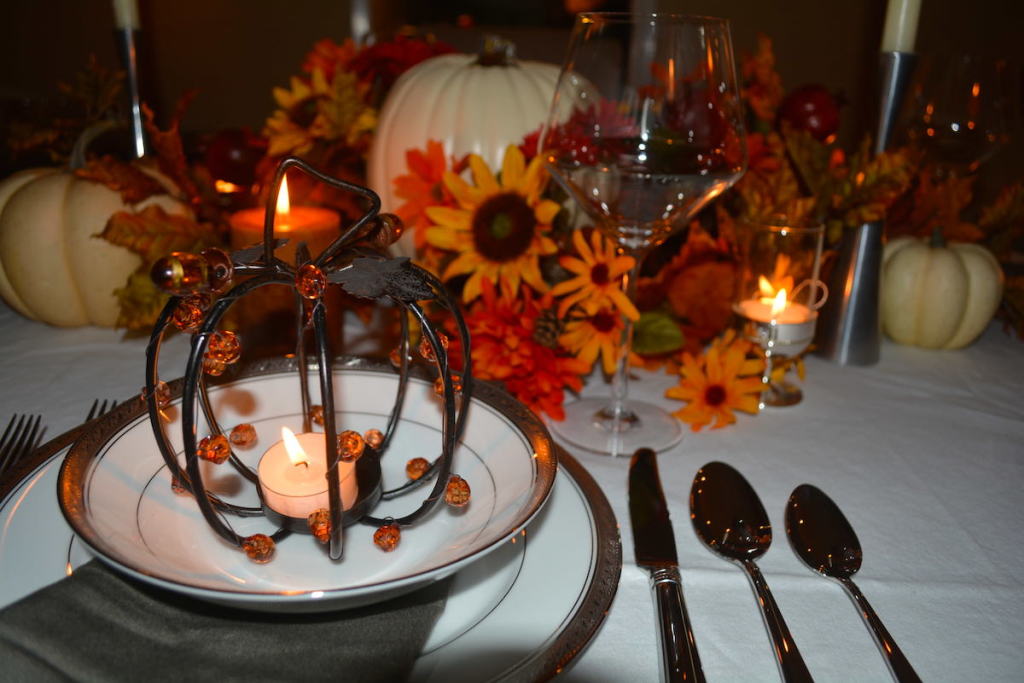 Flickering pumpkin votives set the tone for an intimate dinner party.