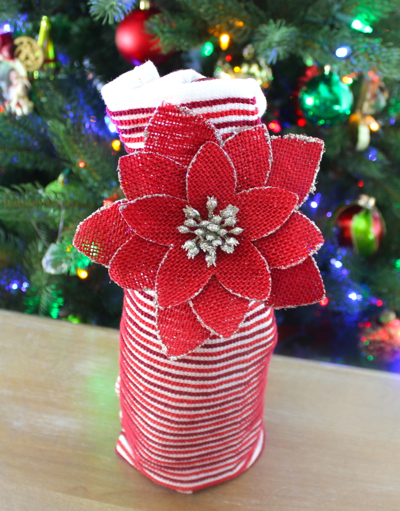 Wine wrapped in a dish towel and ornament: One of four easy DIYs to wrap a bottle of wine in another present this holiday season.