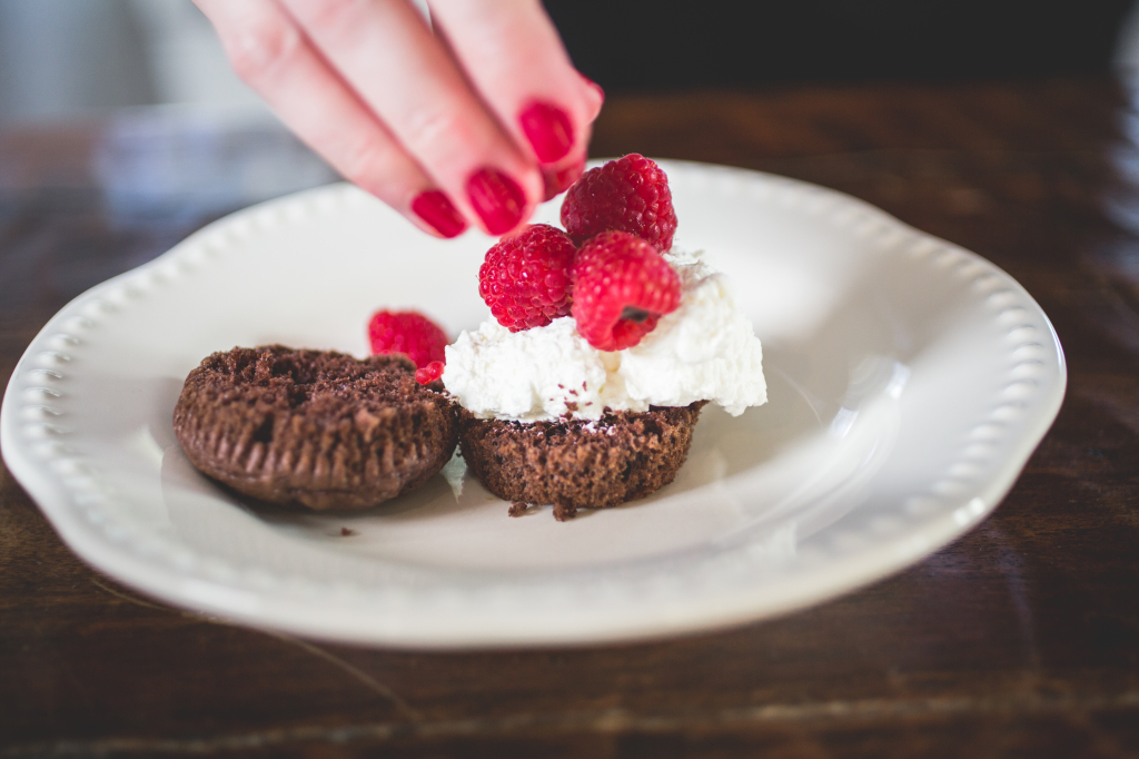 Homemade chocolate cupcakes stuffed with berries and cream