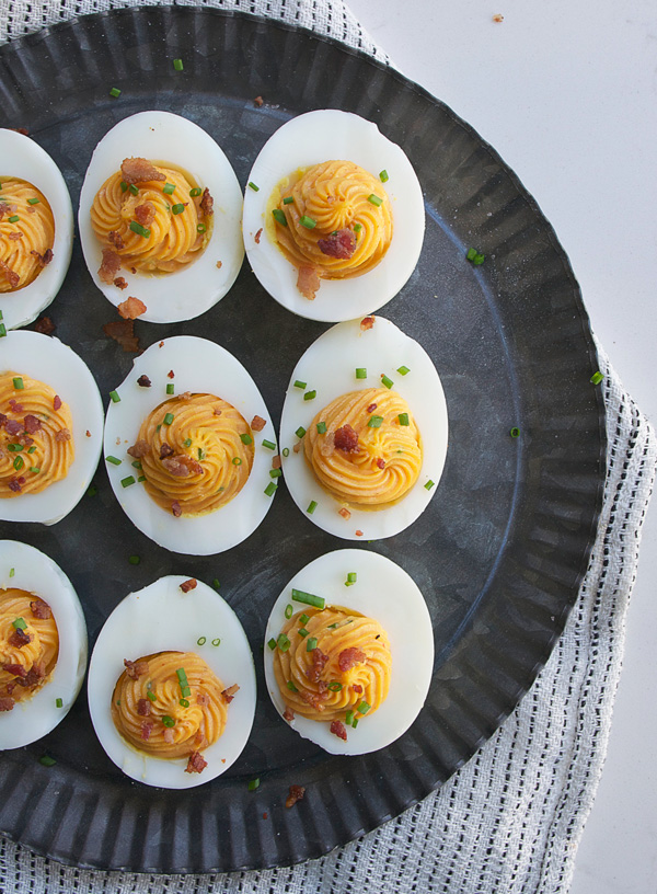 Sriracha Deviled Eggs with Crumbled Bacon: Spicy, creamy, smokey ... what else do you need in an appetizer?