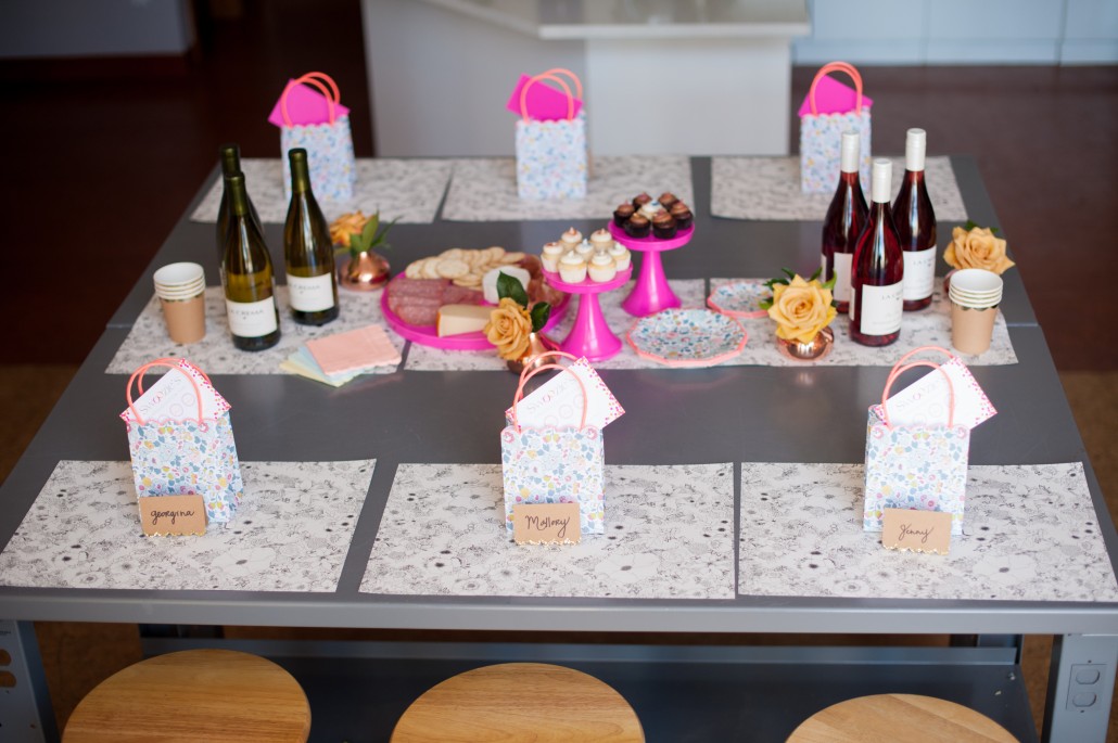 Table design with wine, snacks goodies and place settings for a flower arranging class