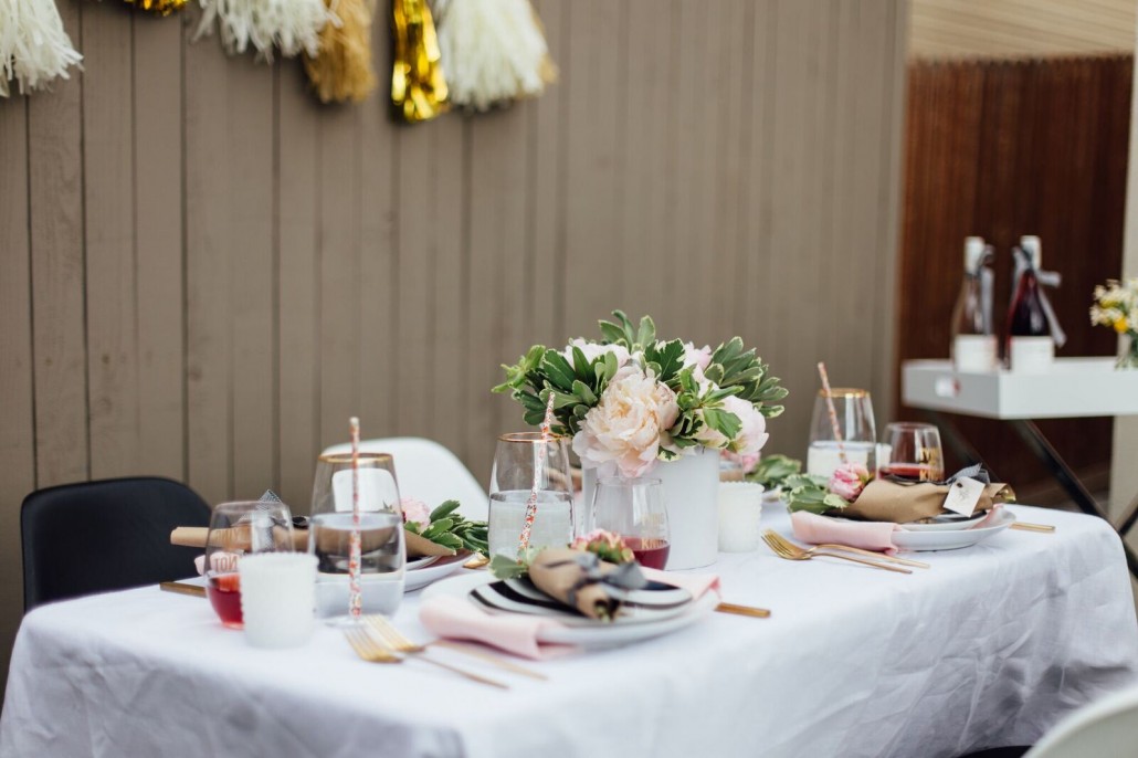 Table decor idea (with a convenient bar cart nearby stocked with wine!) for a DIY bridal shower