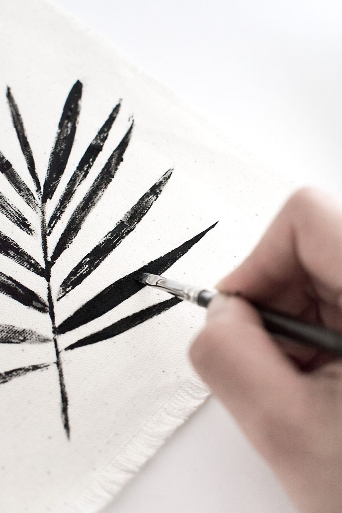 Fill in the leaf with black paint to create DIY Palm Leaf Napkins with a graphic look