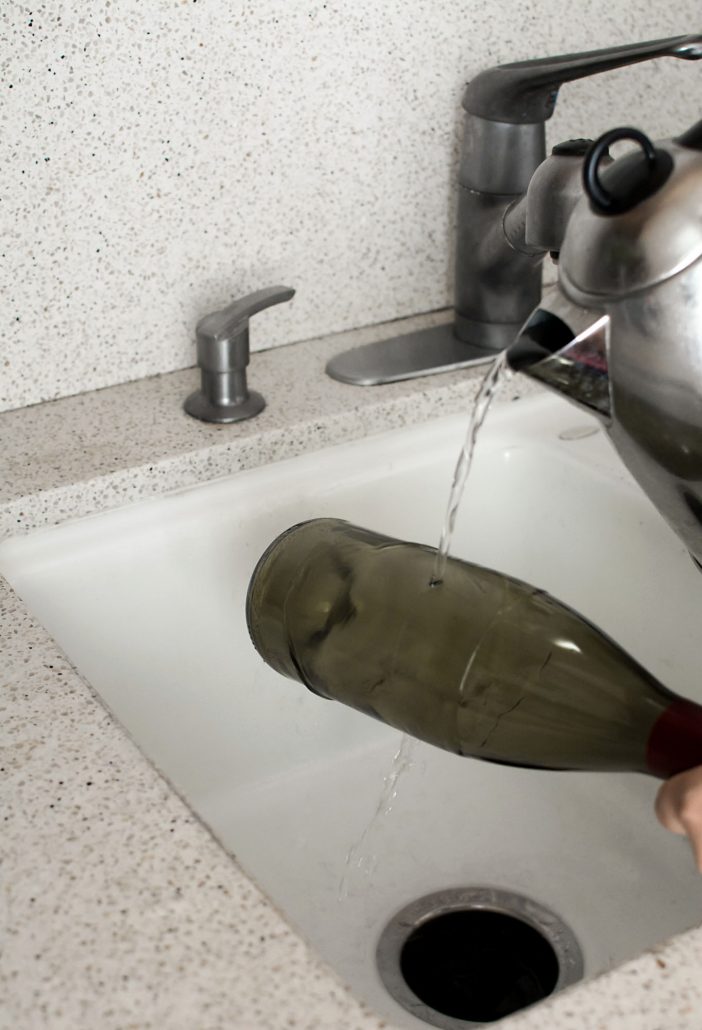 Pour boiling water over the score in a sink, and keep the bottle close to the bottom of the sink.