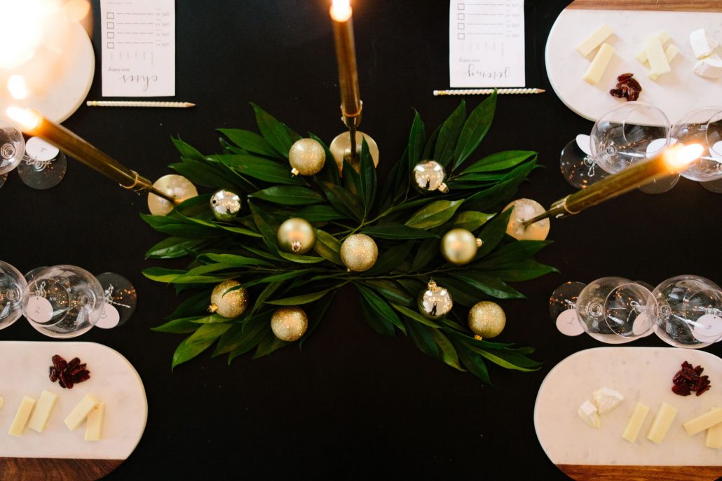 Festive centerpiece with leaves and gold ornaments for a blind wine tasting