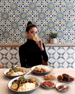 marisel drinking wine with latin dishes